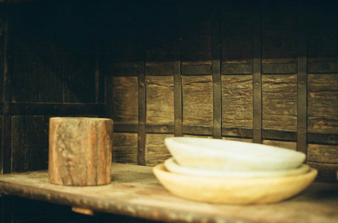 Old books stacked on a wooden shelf