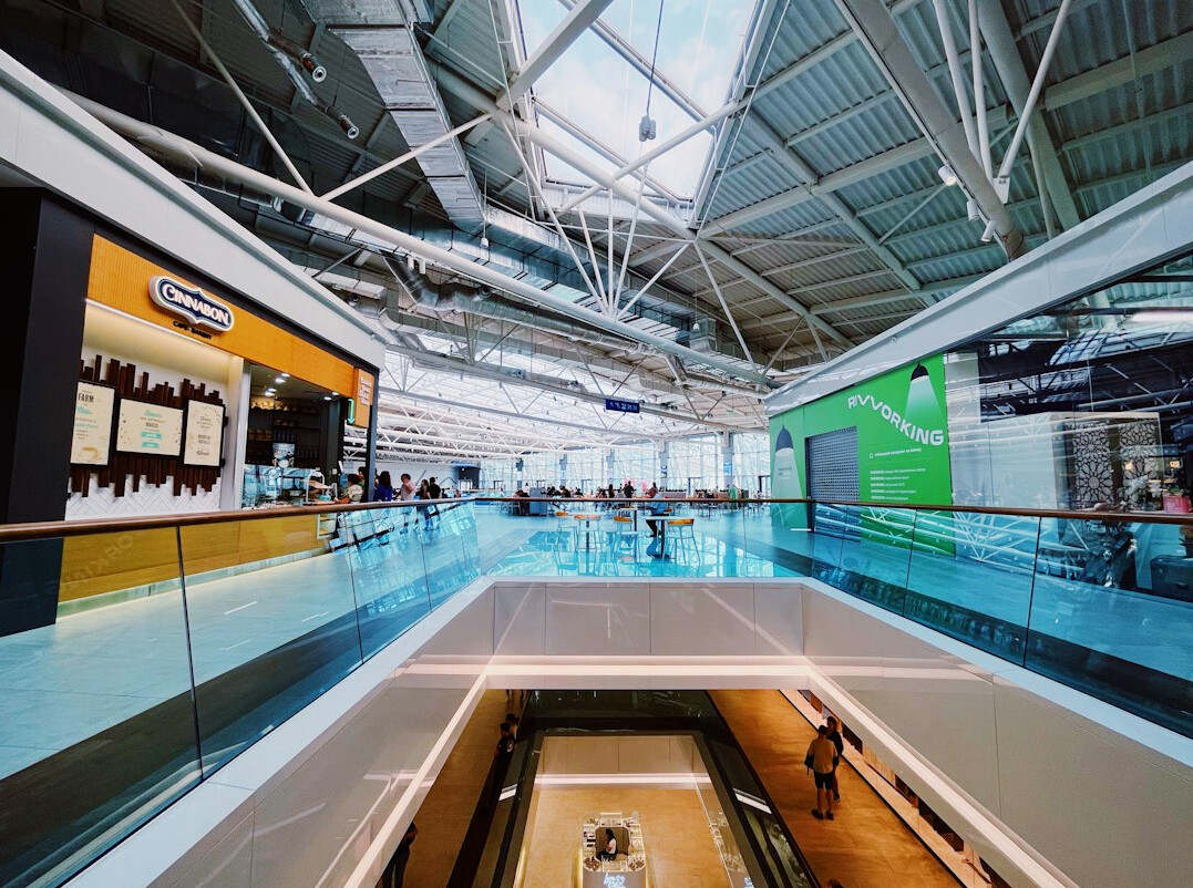 Modern open-plan digital newsroom with large screens
